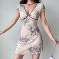 Front view of cream floral dress with V-neck, contrast purple trim and A-line skirt