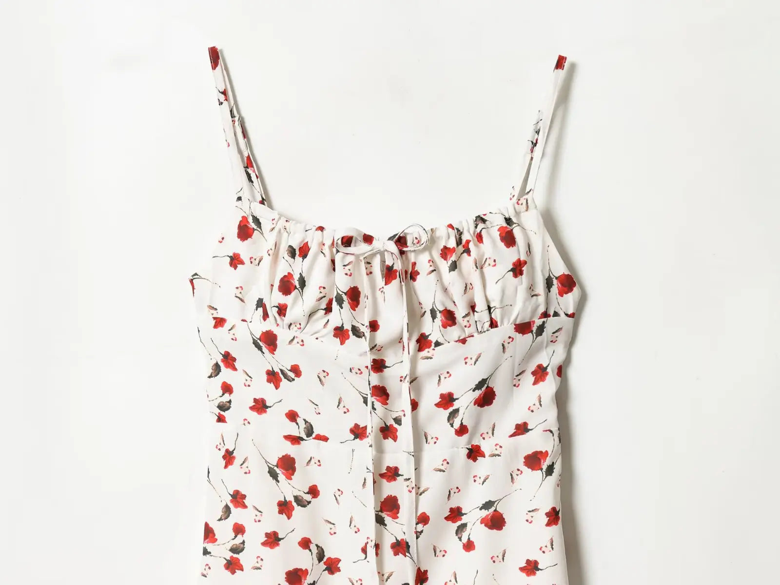 Close-up of spaghetti straps and ruched square neckline on cream red rose midi dress