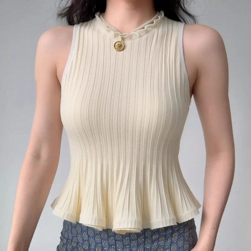 Model wearing cream white ribbed-knit tank with ruffled neckline and peplum hem, fitted sleeveless sweater