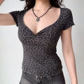 Outfit view of dark gray leopard print top styled with dark jeans, highlighting the stretchy fabric