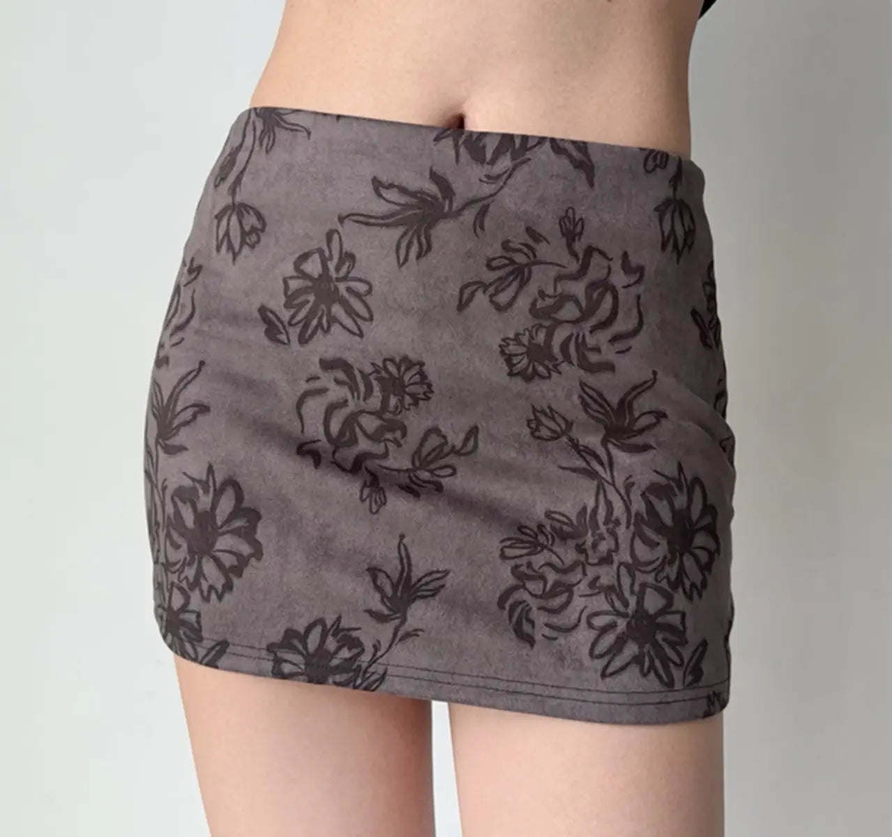 Close-up view of dark grey floral print mini skirt