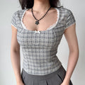 Model wearing gray plaid square-neck top with white lace trim, sweetheart bust and fitted corset-style silhouette
