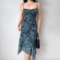 Model wearing green butterfly print spaghetti strap dress, close-up front pose
