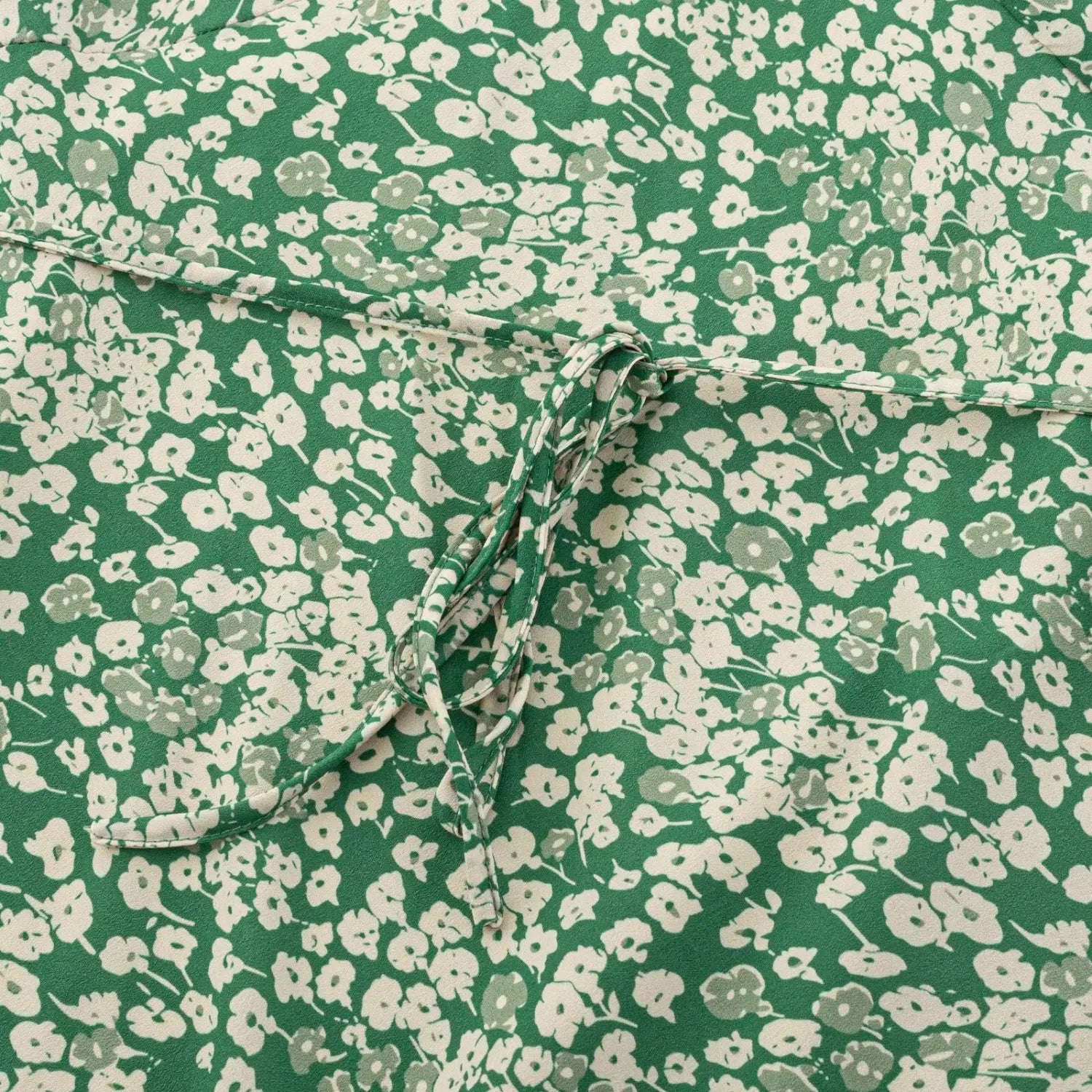 Close-up of waist self-fabric tie on green floral long dress, same floral pattern drawstring design