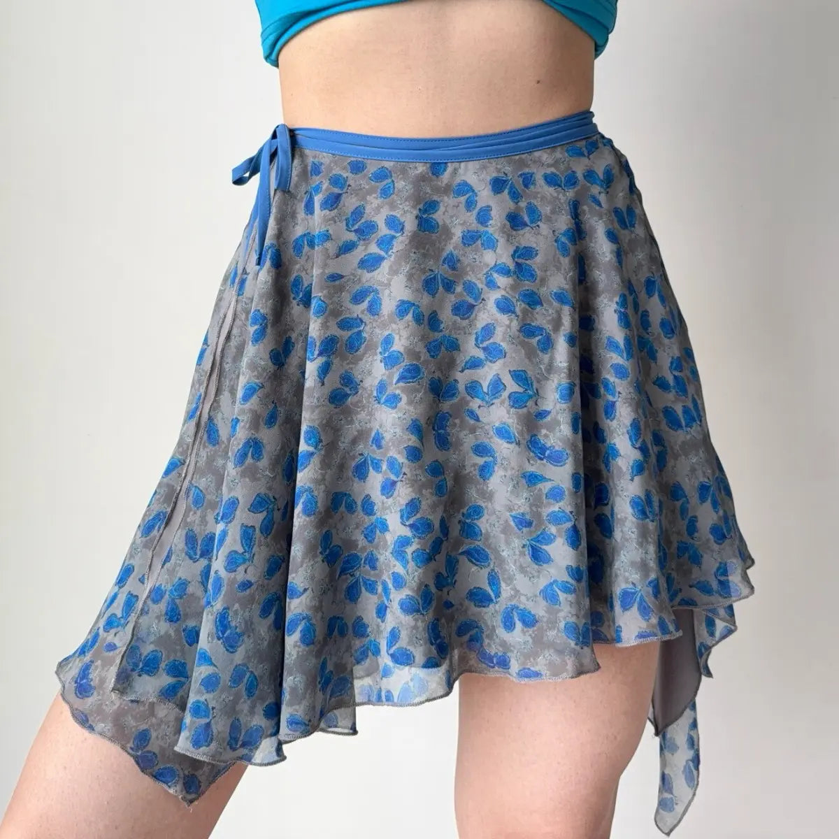 Model in grey blue floral wrap skirt, front view
