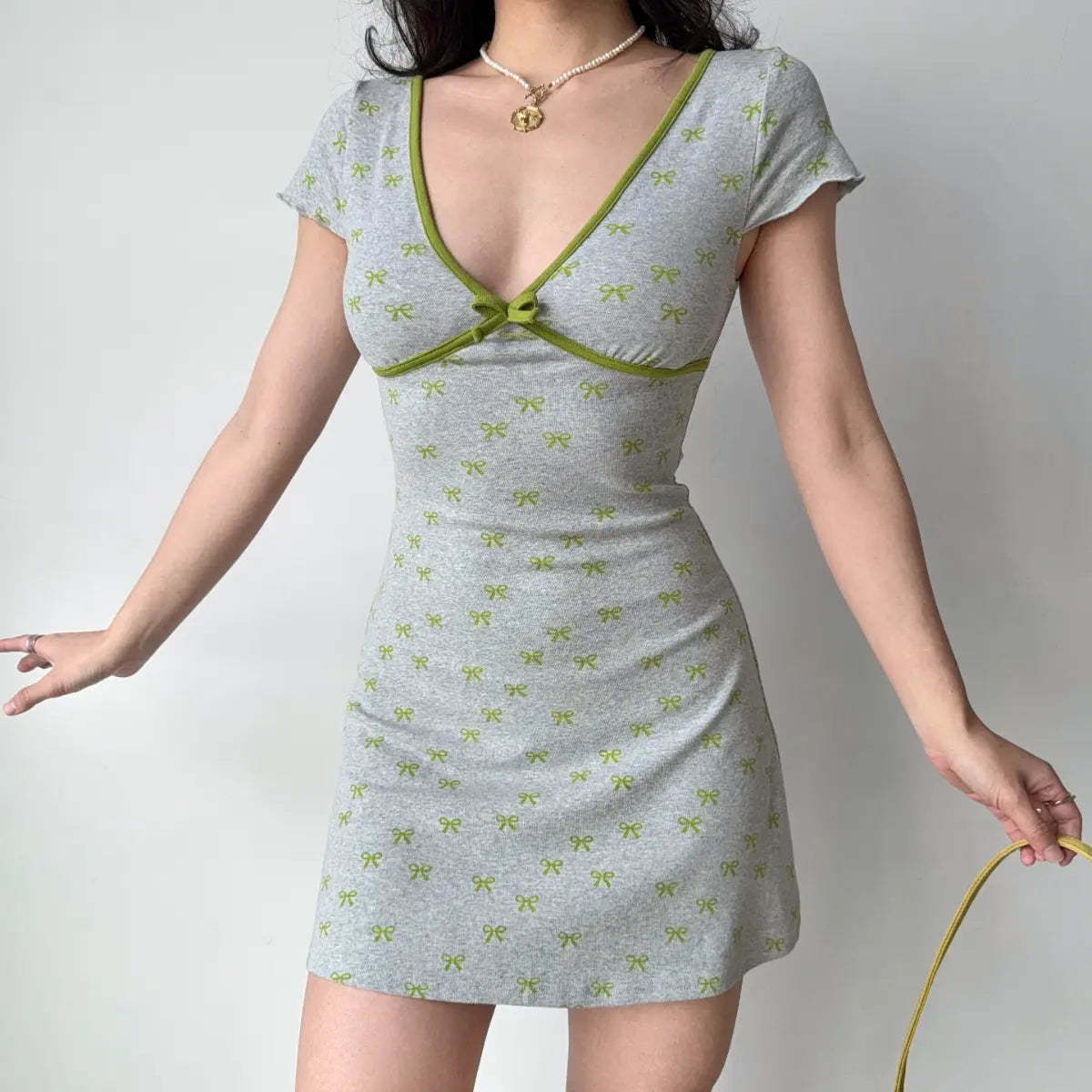 Grey knit mini dress with green bow print