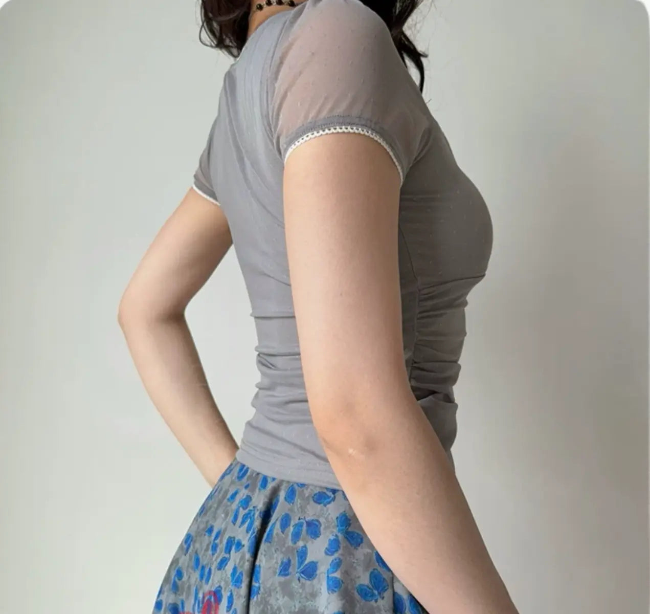 Side view of grey mesh fitted top