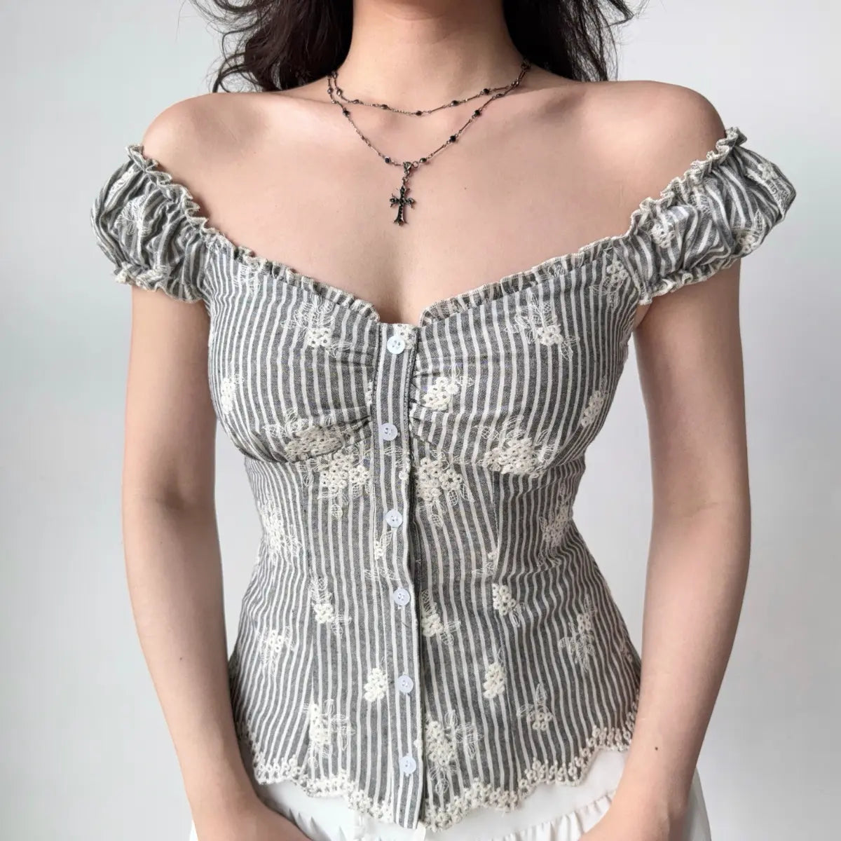 Grey striped top styled as off-the-shoulder