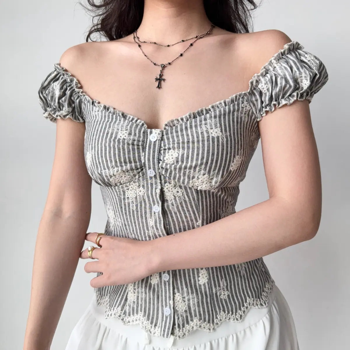 Side view of grey striped embroidered bustier top