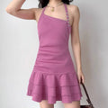 Model wearing hot pink halter-neck mini dress with asymmetric straps and tiered ruffled hem