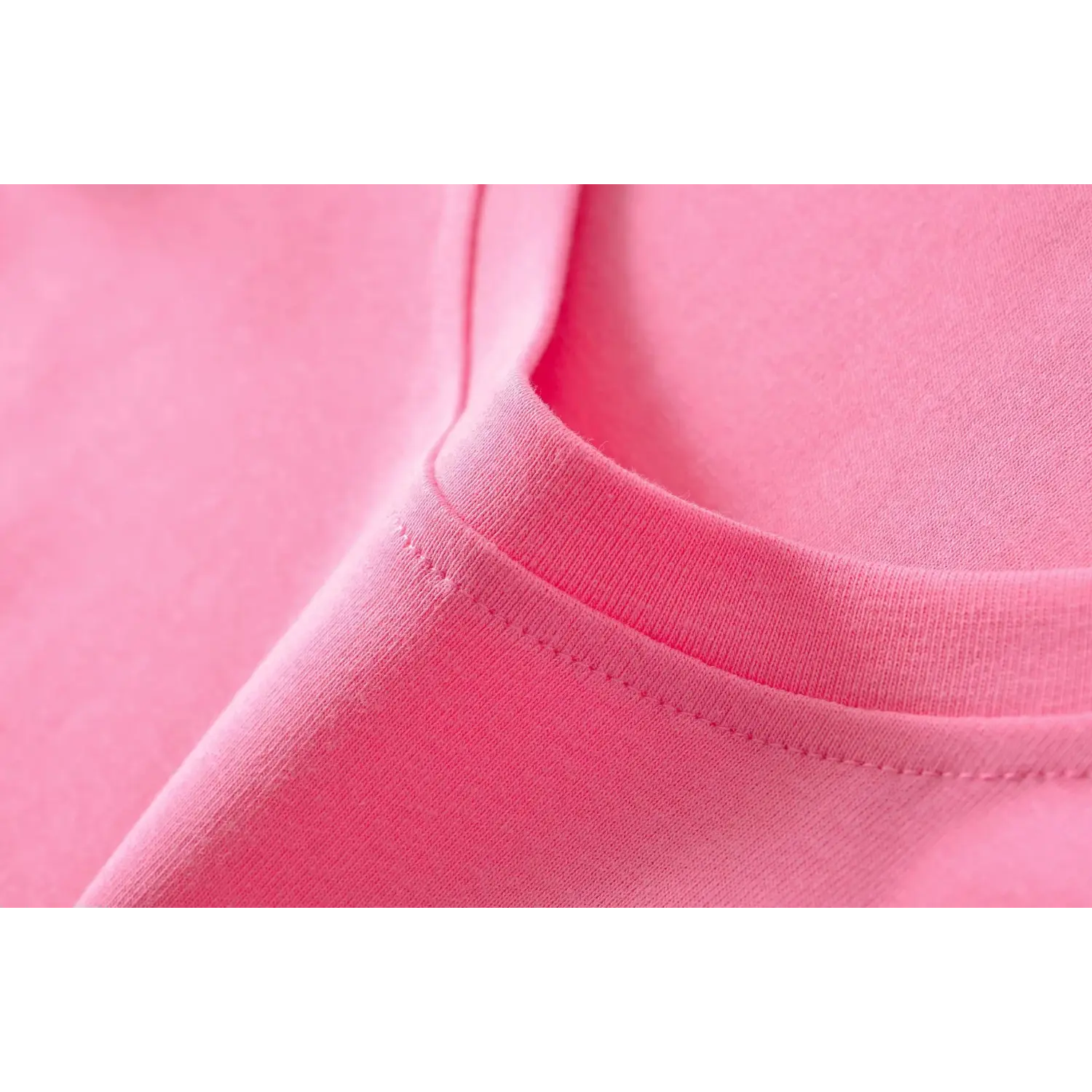 Macro shot of soft ribbed knit fabric texture of hot pink U-neck slim tee