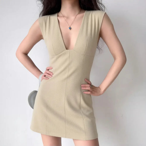 Model wearing khaki deep V-neck sleeveless bodycon dress, minimalist chic mini dress