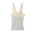 Hanger view of cream and mint green tank top showing the lace-trimmed bustier-style bodice and contrast color-block design