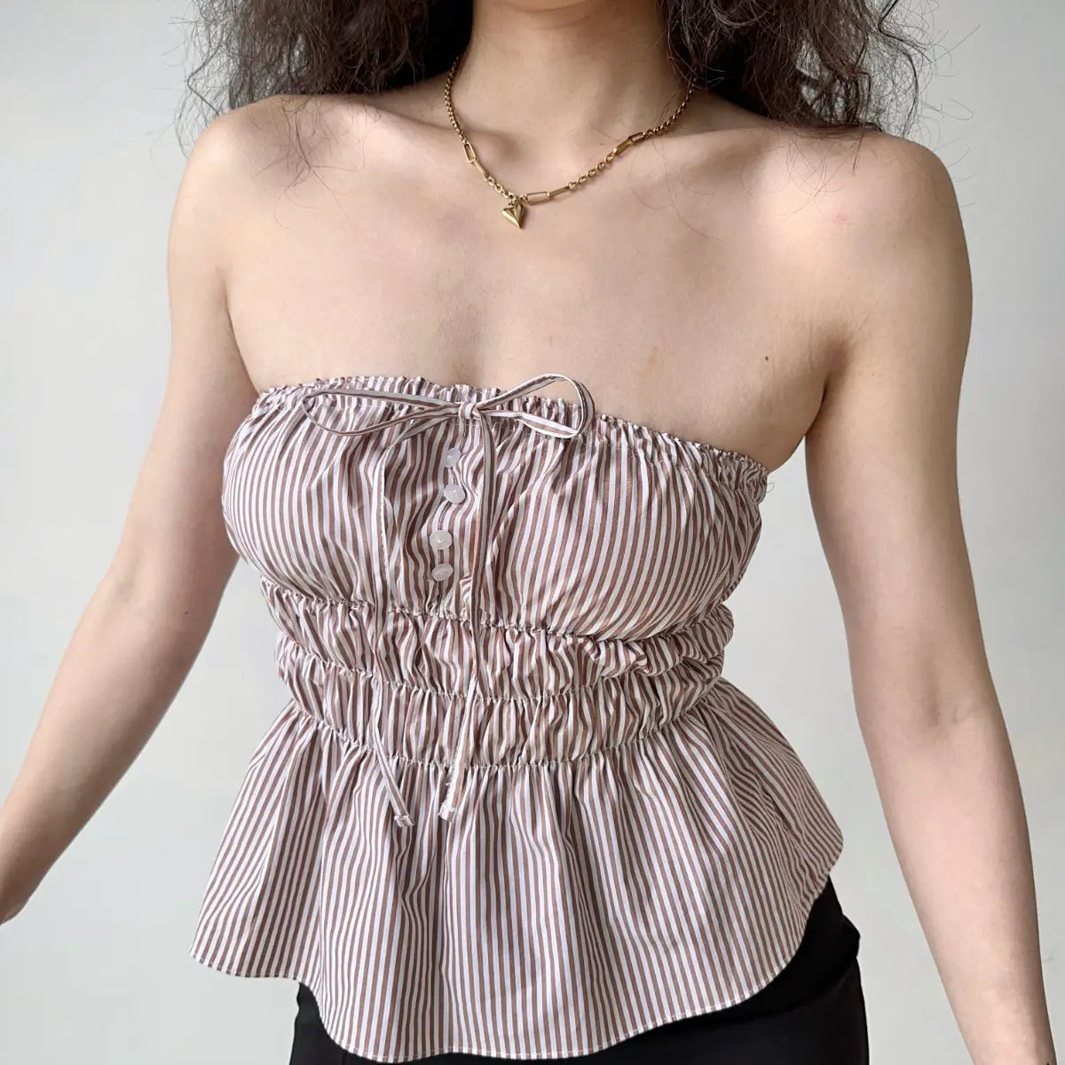 Model in lavender ruched peplum bandeau top, front view