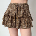 Model wearing leopard print ruffled mini skirt, front view