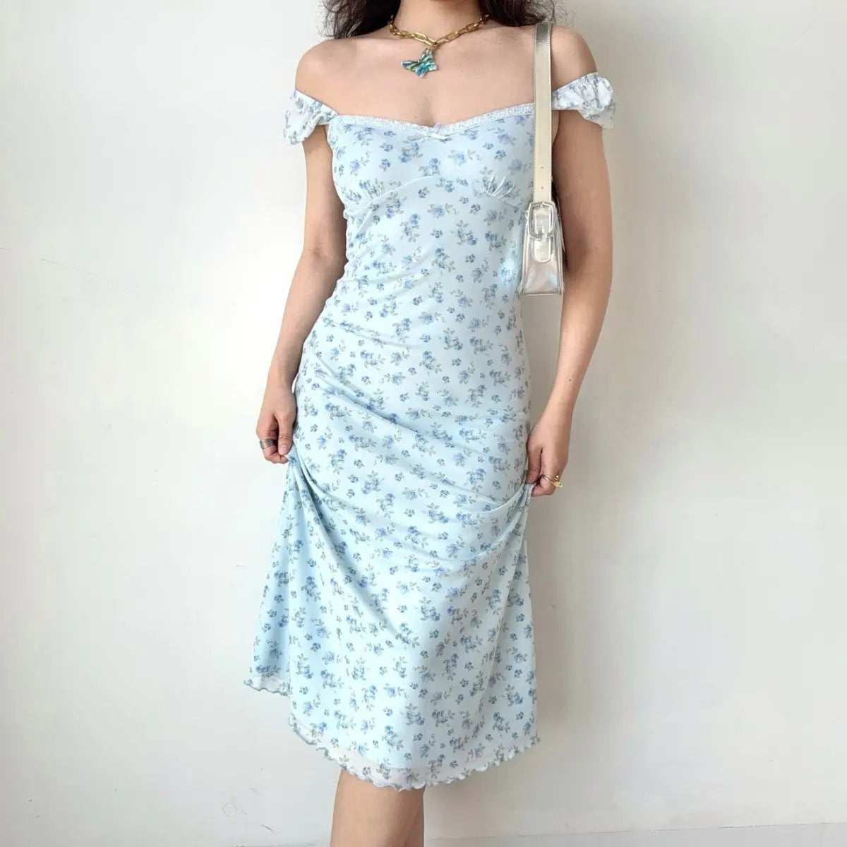 Light blue floral dress styled with a white bag