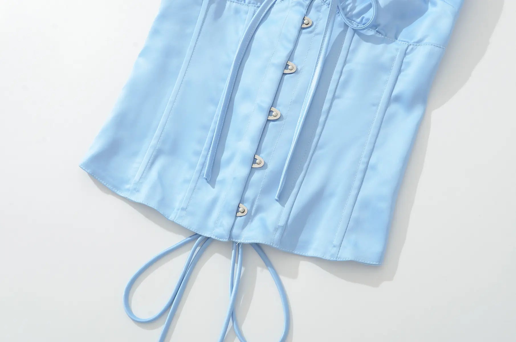 Button detail of light blue halter corset top