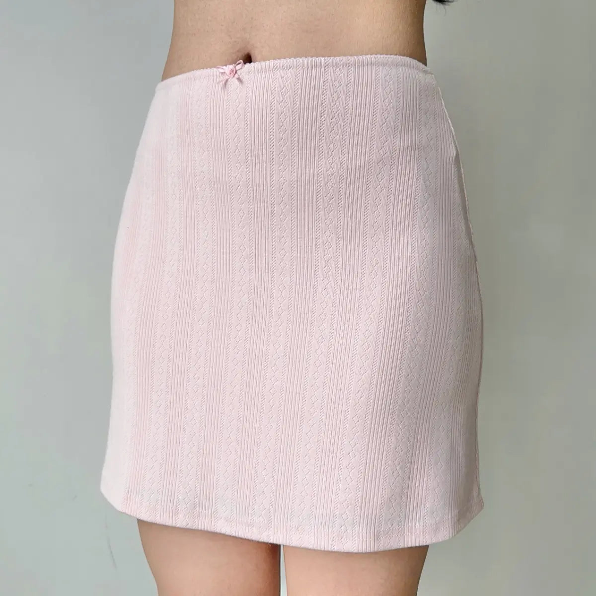 Full front view of light pink jacquard mini skirt
