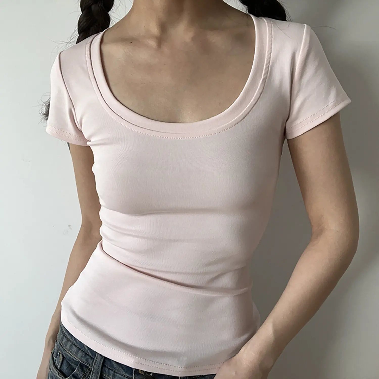 Front view of soft light pink low U-neck stretch ribbed fitted short sleeve top