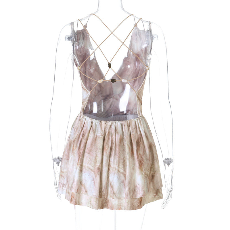 Back view on mannequin of neutral beige marble tie dye print criss cross back beaded strap open back high waist flared hem mini dress, elegant sexy party dress