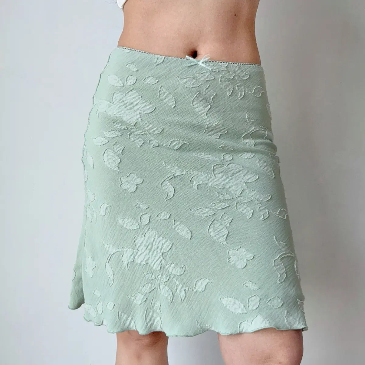 Close-up view of mint green floral jacquard fabric