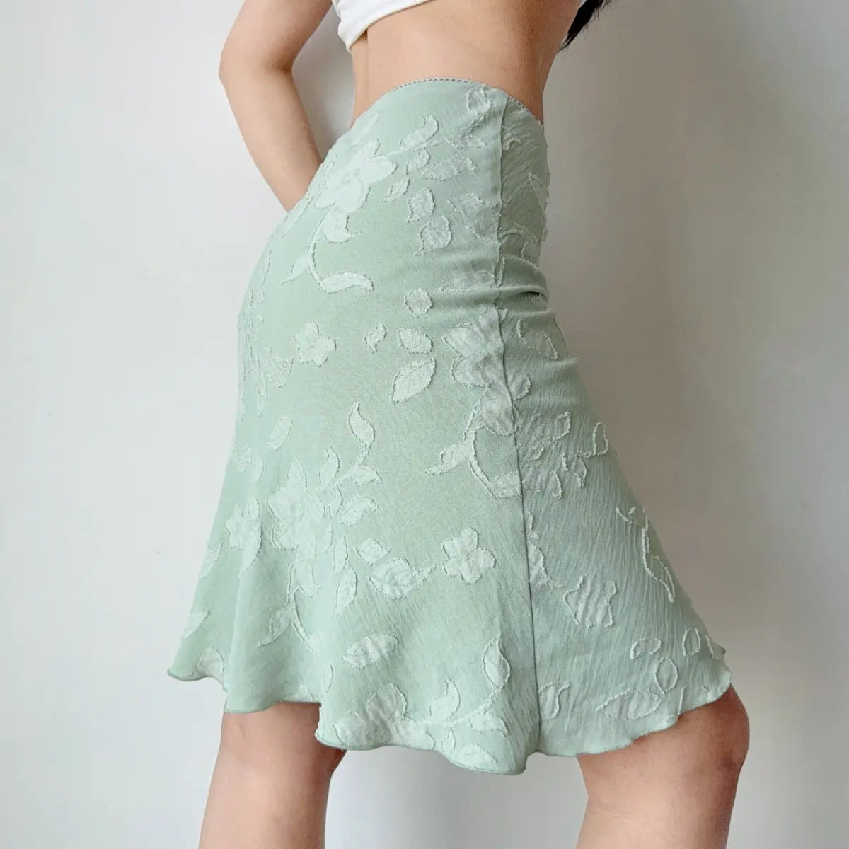 Side view of mint green floral jacquard midi skirt