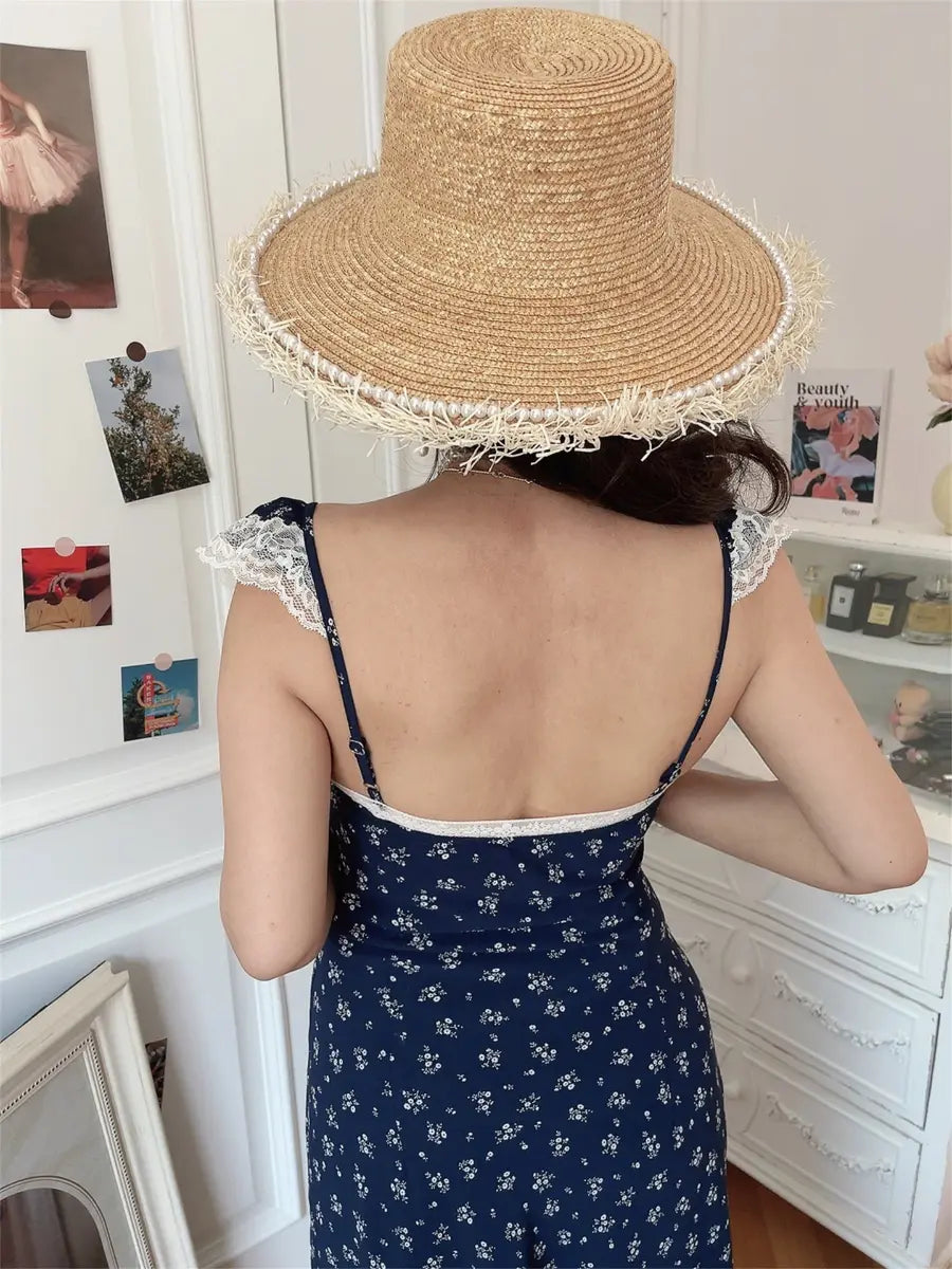 Model in navy ditsy floral lace-trim maxi dress, back view