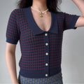 Model wearing navy red stripe knit cardigan with Peter Pan collar and button front, retro-inspired short-sleeve sweater