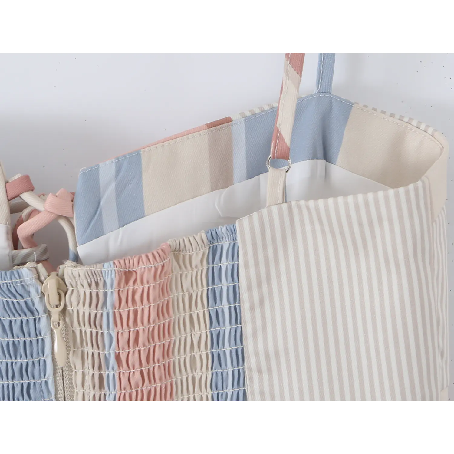 Inner waist lining close-up, matching pastel plastic invisible zipper within wide shirred smock fabric