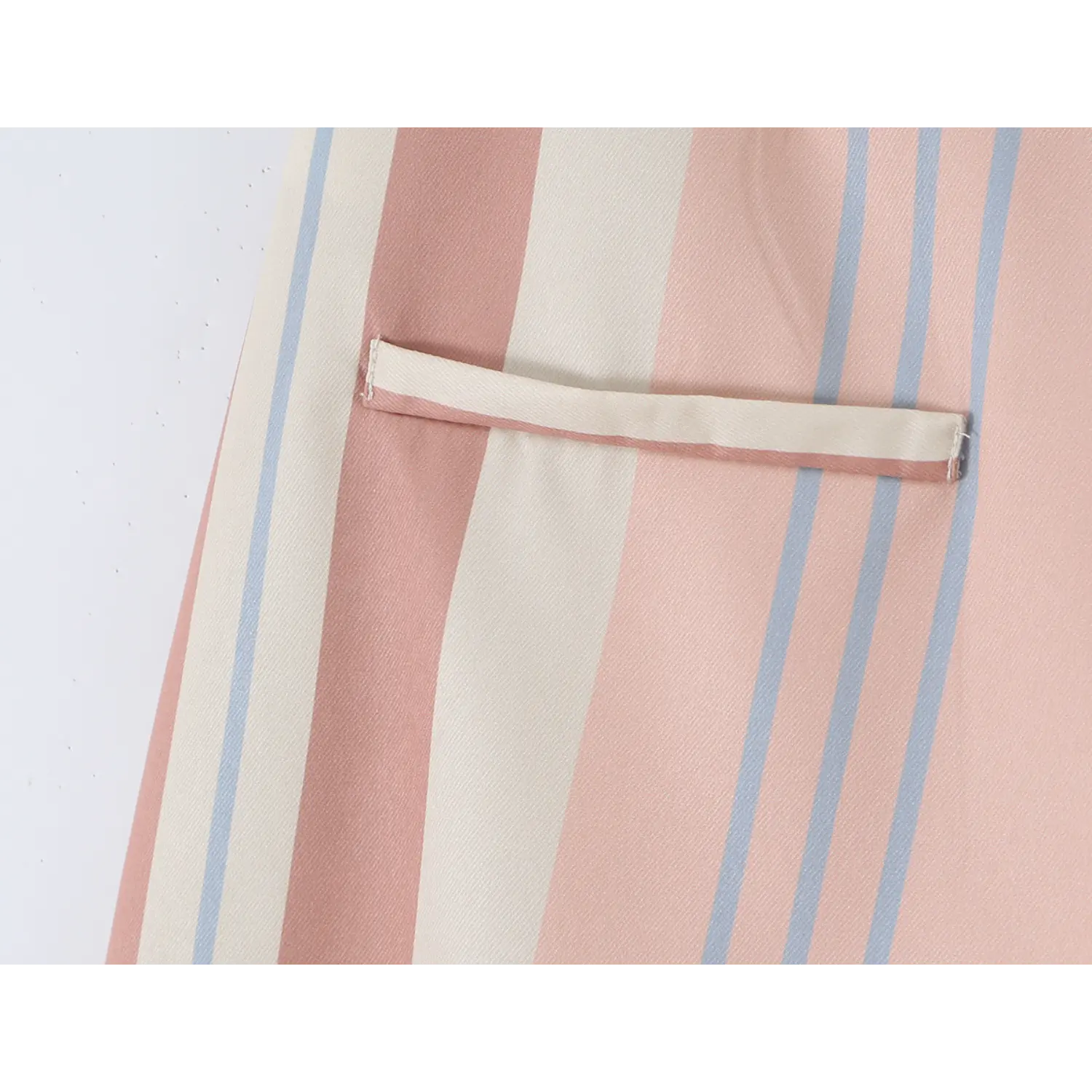 Rear horizontal welt pocket close-up, solid pink binding edge, uniform even stitching