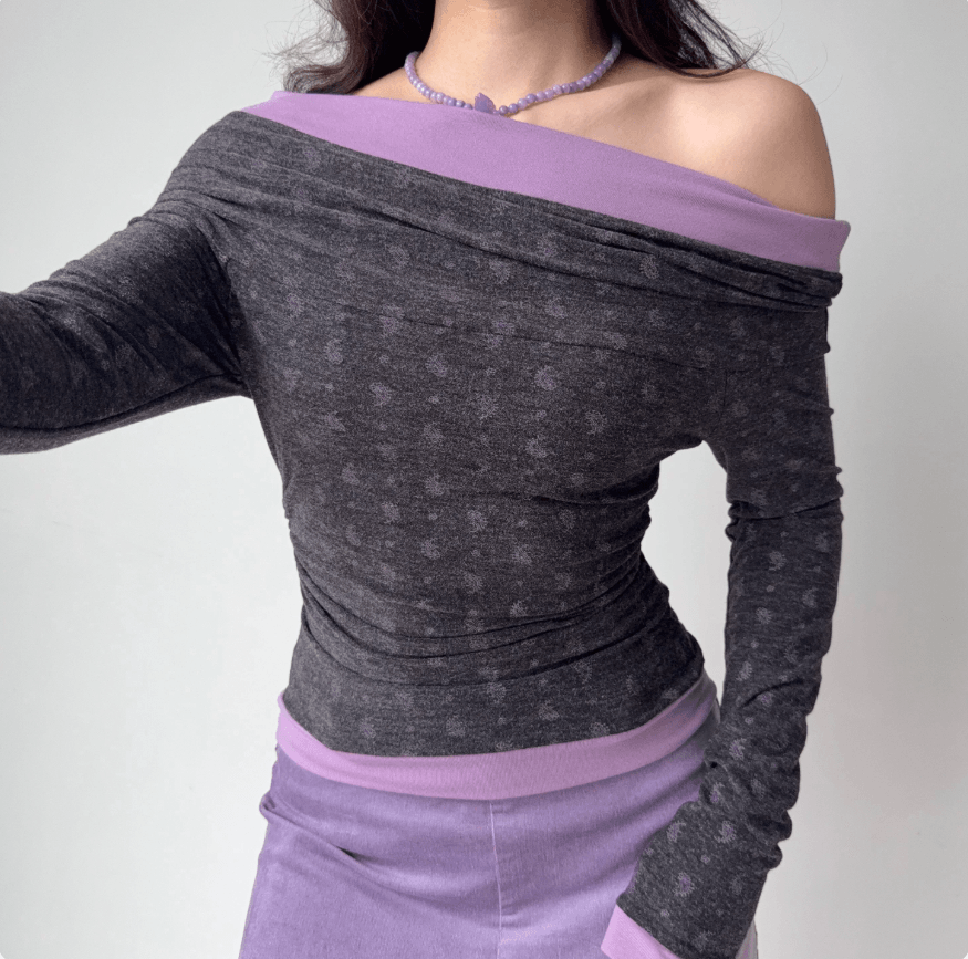 Slant front view off shoulder ruched long sleeve cropped top, grey paisley print purple contrast trim slim fitted blouse
