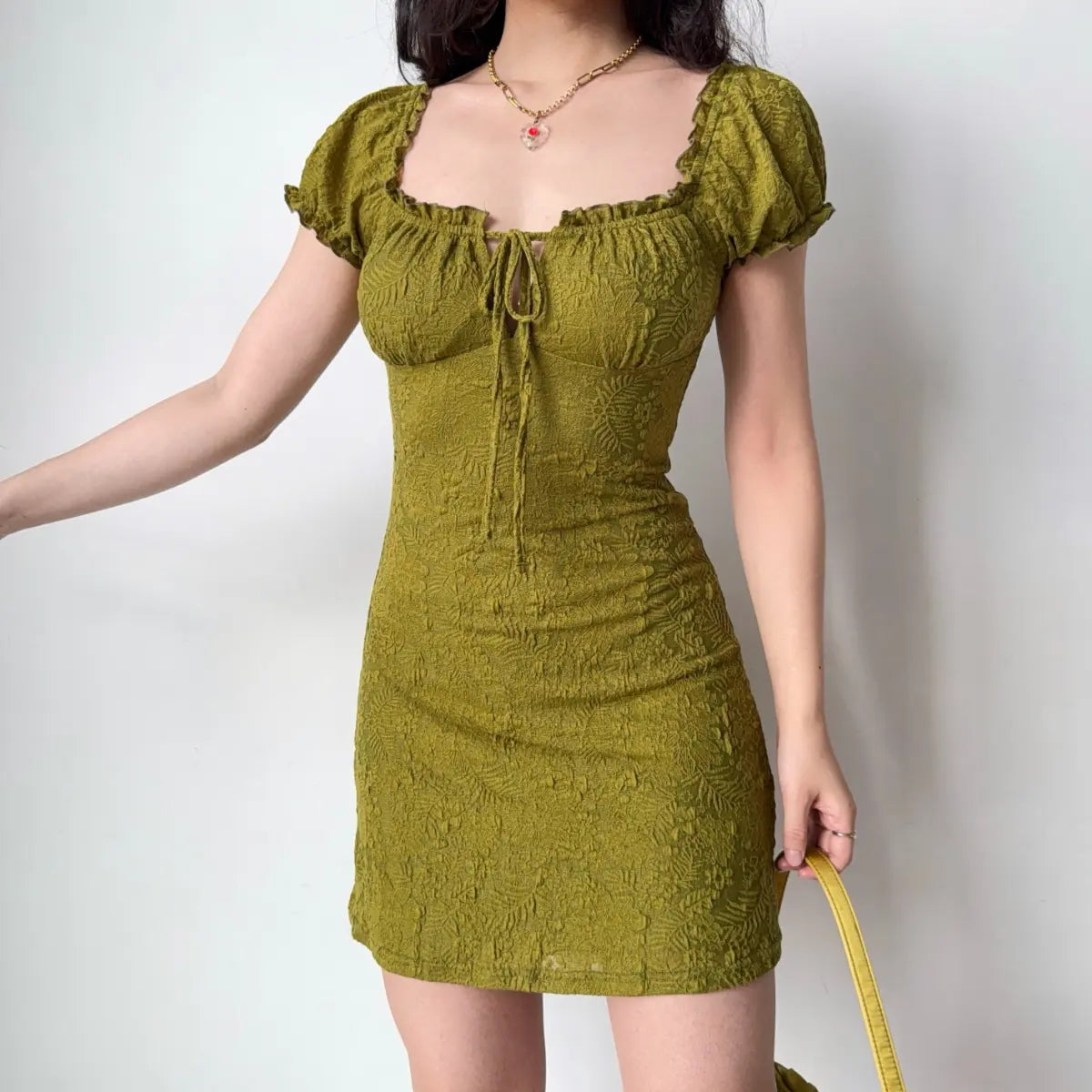 Side view of olive green puff sleeve dress