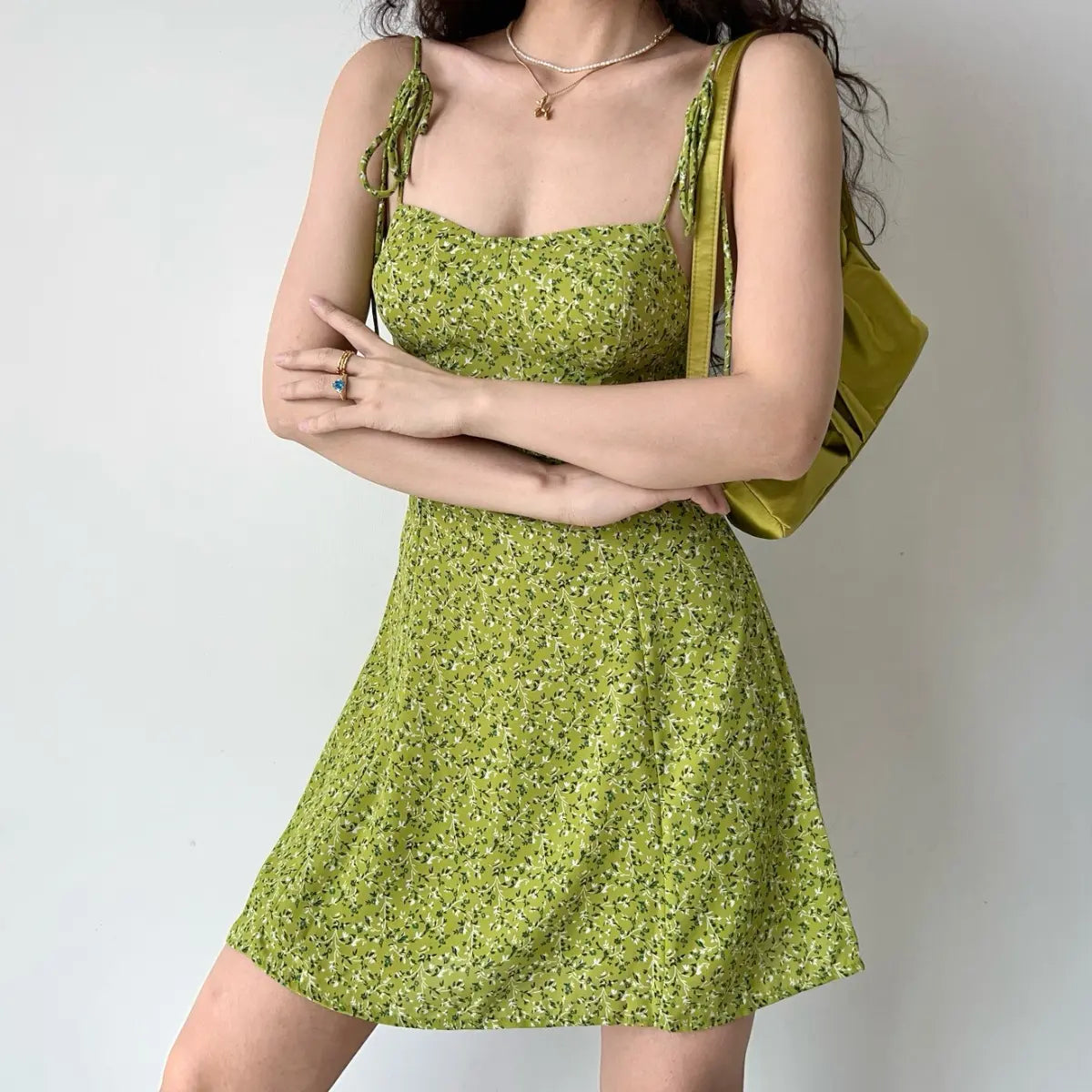 Floral cami dress styled with arms crossed