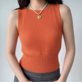 Model wearing orange chunky-knit cropped tank with ribbed hem, fitted sleeveless sweater top