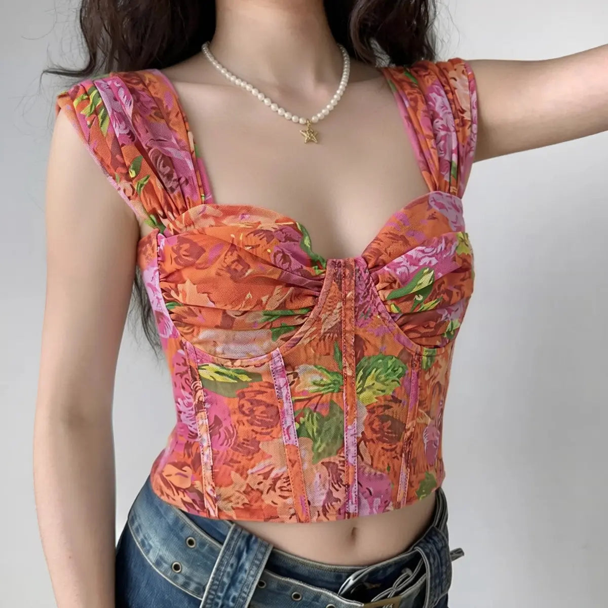 Model wearing orange pink floral print corset-style cami top with sweetheart neckline, bustier mesh top