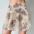 Model wearing beige paisley print ruffled mini skirt