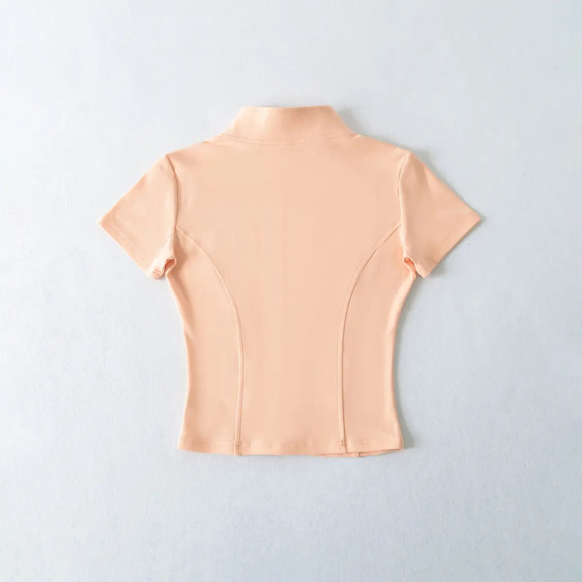 Back view of peach zip-up cropped t-shirt
