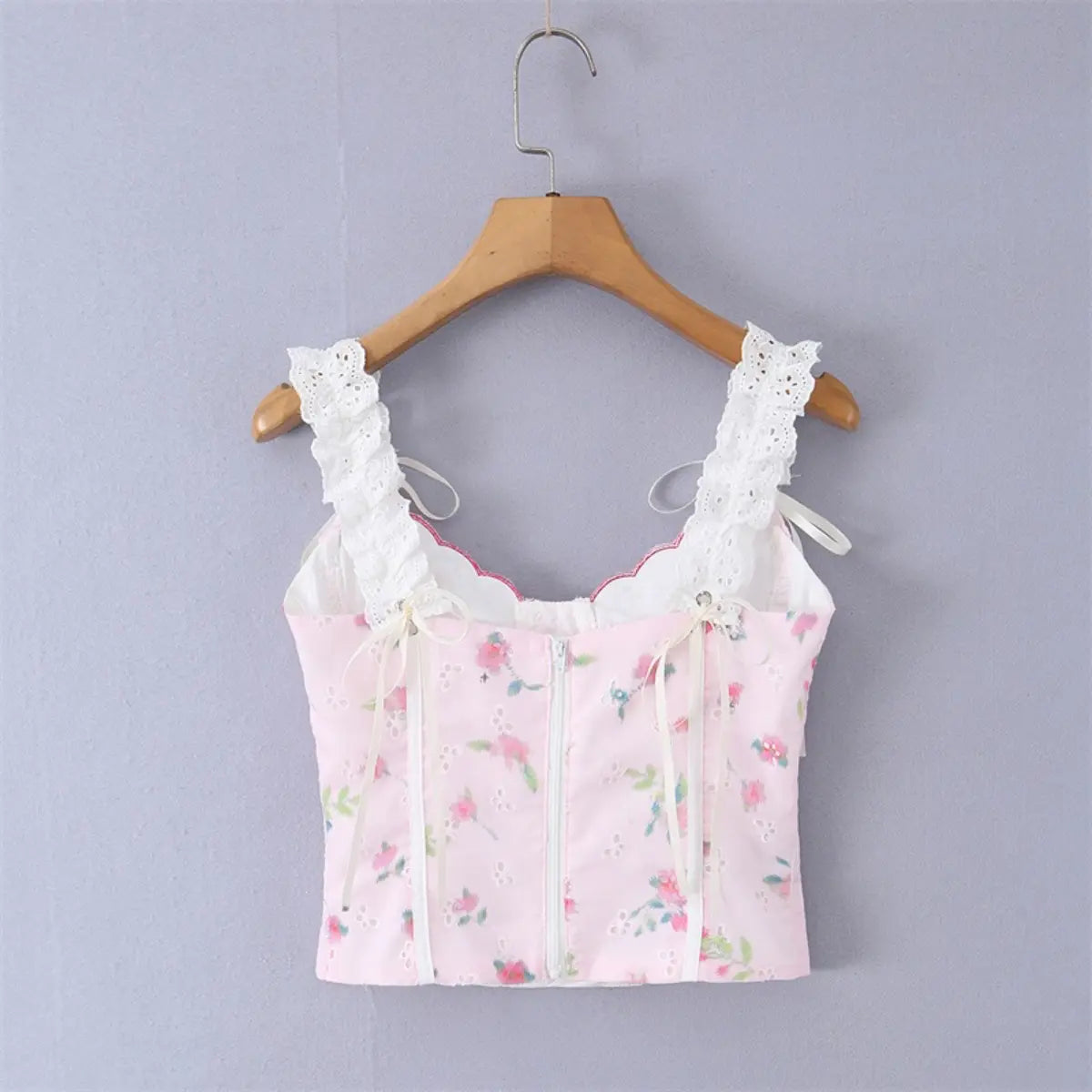 Pink floral lace camisole top, back view on hanger