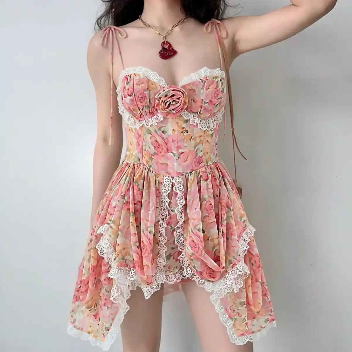 Front flat view pink floral print lace-trim tie-strap bustier mini dress with rose detail, women's romantic summer dress