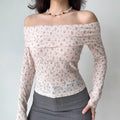 Model wearing pink floral-print off-the-shoulder top with ribbed texture and sheer lace detail, fitted long-sleeve blouse