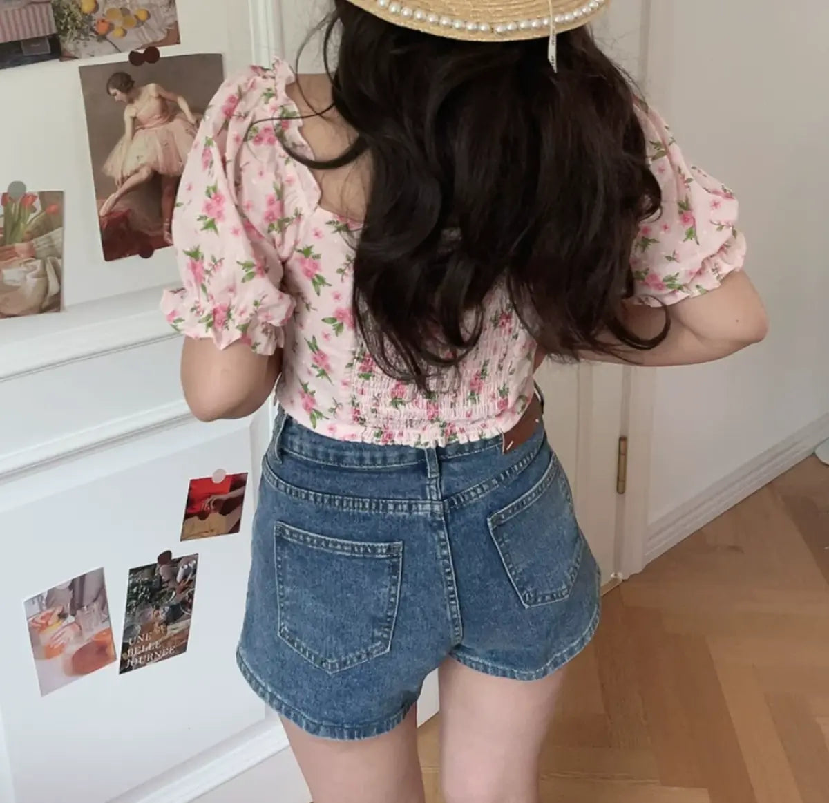 Back view of pink floral print cropped top with puff sleeves and fitted waist