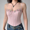 Model wearing pink lace cami top with floral embroidery and sweetheart neckline, bustier-style spaghetti-strap top