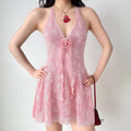 Model wearing pink lace halter mini dress, front view