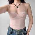 Model wearing pink lace-trim spaghetti-strap corset top with sweetheart neckline, feminine bustier-style cami