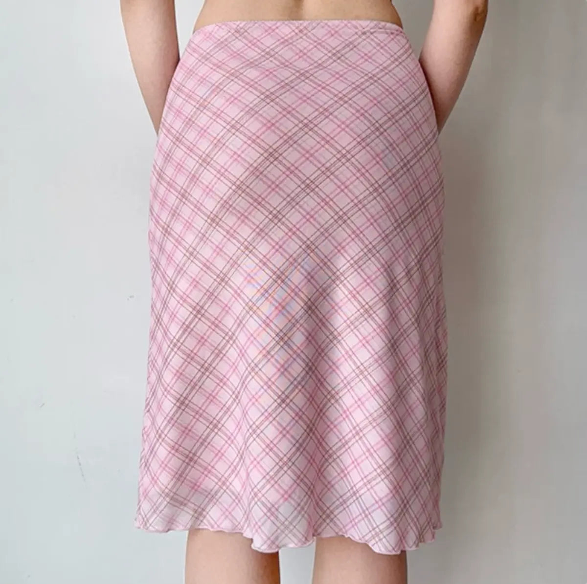 Model wearing pink plaid mesh midi skirt, back view
