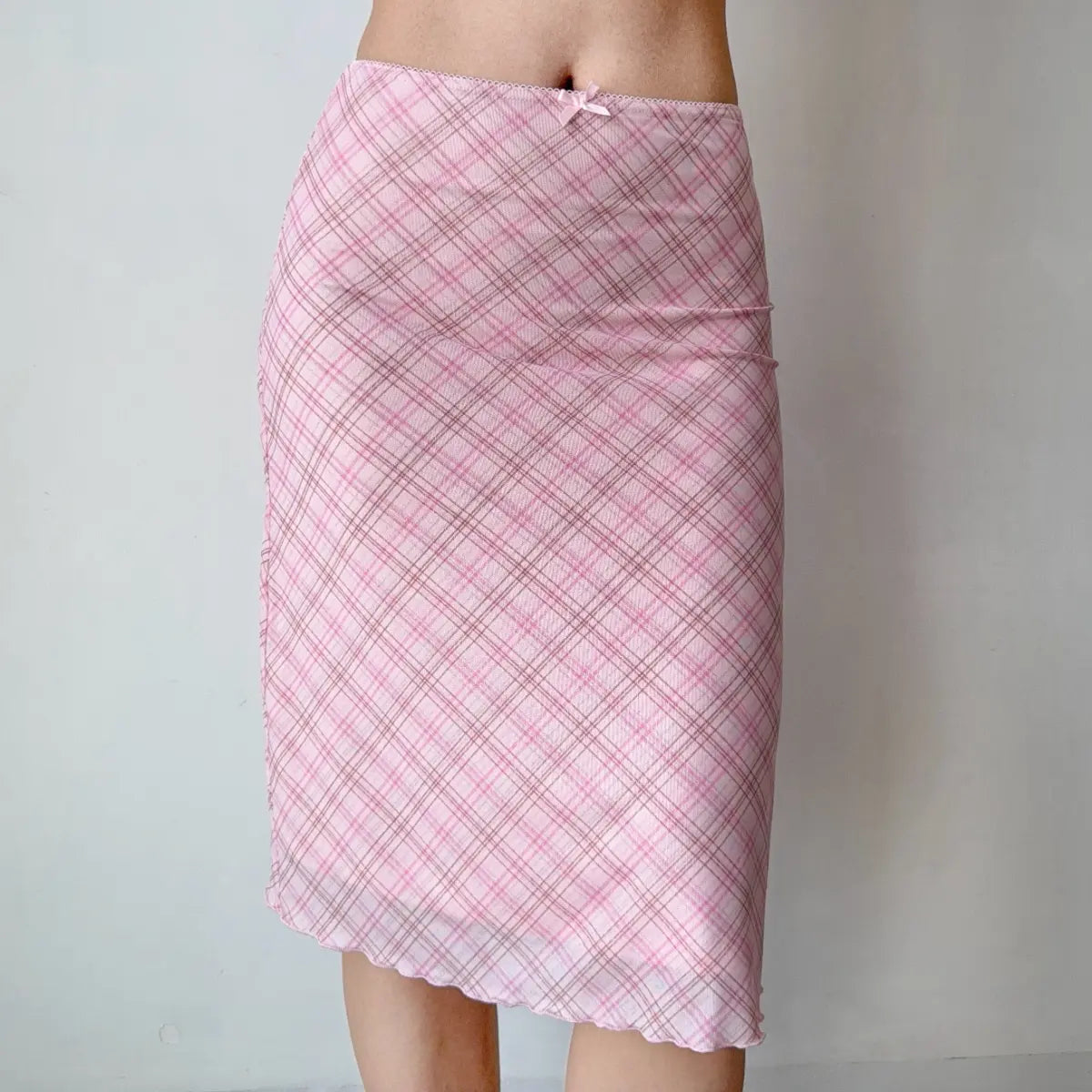 Model wearing pink plaid mesh midi skirt, front view