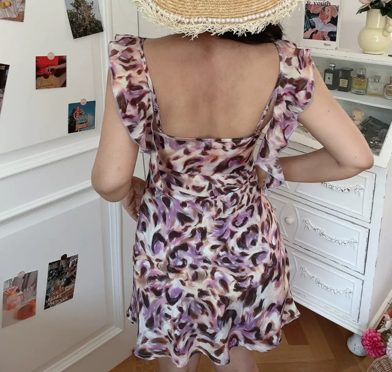 Back view of pink purple leopard print mini dress with ruffled straps and low back design