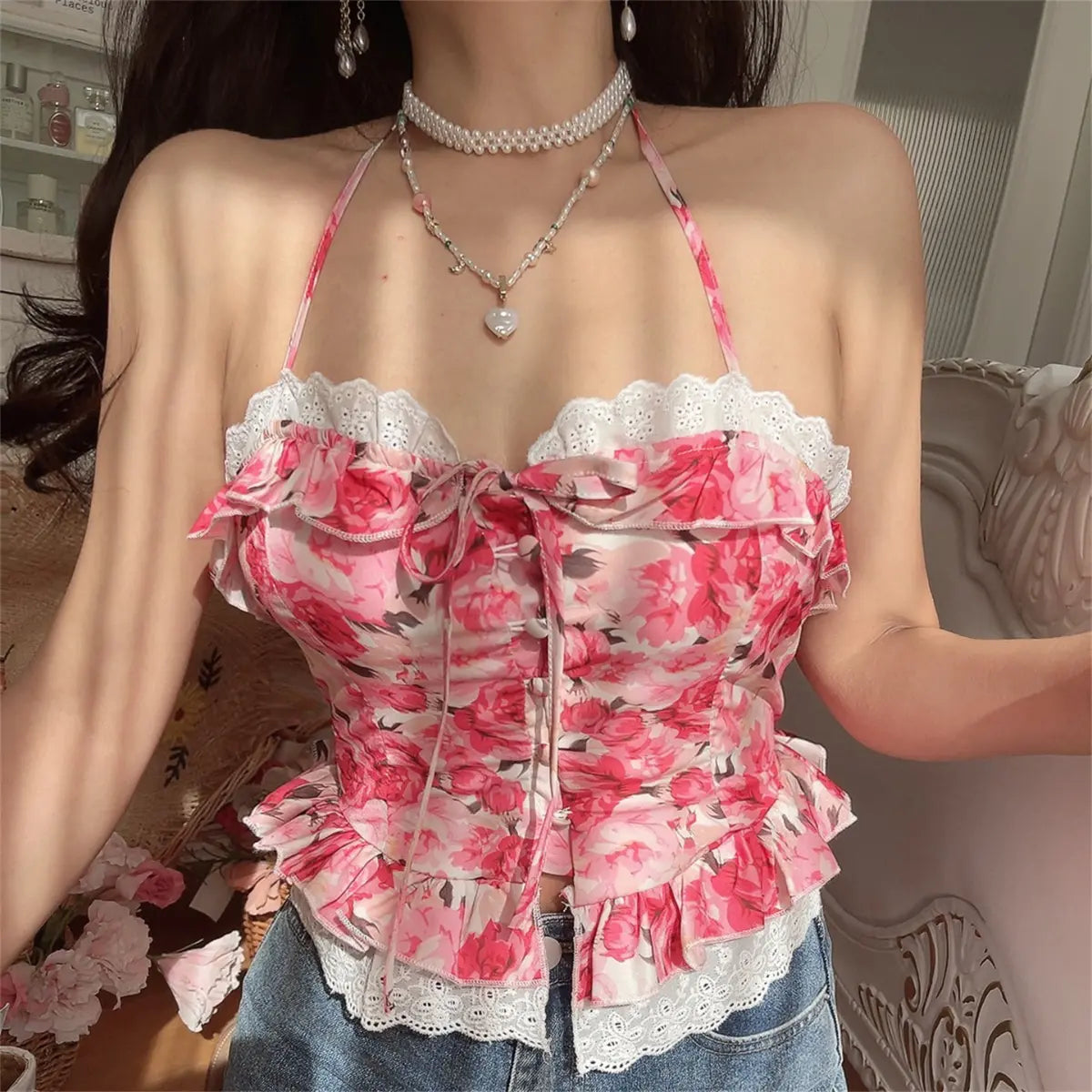 Another close-up view of model wearing pink rose print halter cami top