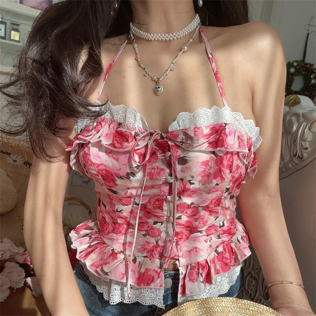 Model wearing pink rose print halter cami top, front view