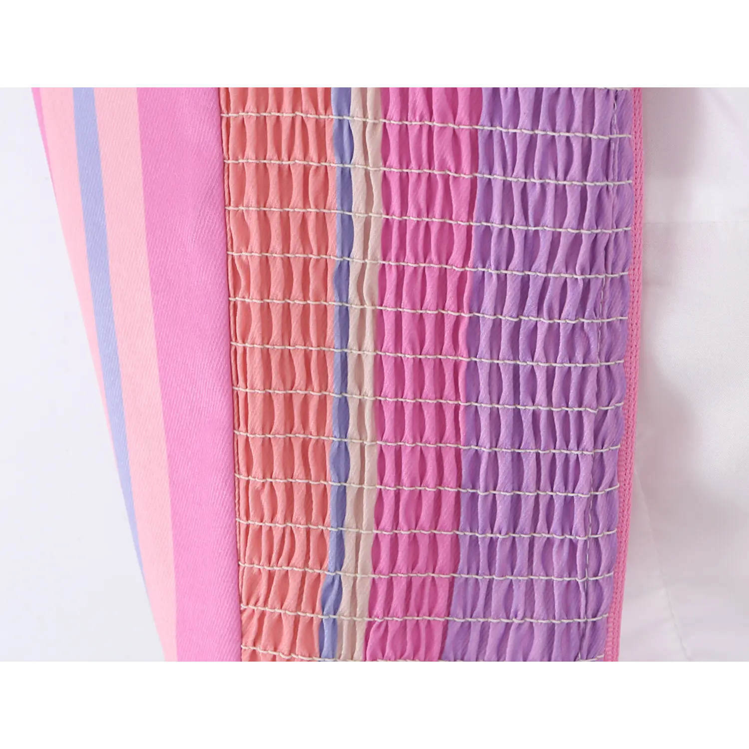 Macro texture shot of wide horizontal elastic smocked shirring on striped woven back panel